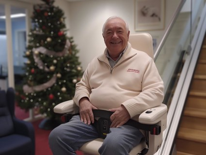 A pensioner rides a stair lift up a flight of stairs, AI generated