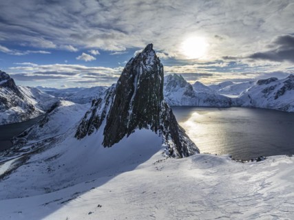 Aerial view of Bergen by the sea, fjord, sunbeams, winter, snow, Mount Segla, Senja, Troms,