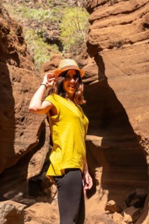 Portrait of a woman with hat in the limestone canyon Barranco de las Vacas in Gran Canaria, Canary