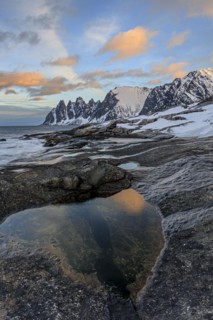 Rocky coast in front of Bergen, sea and pond, morning mood with clouds, winter, Tungeneset, Senja,