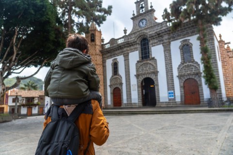 A mother with her son visiting the Basilica of Nuestra Senora del Pino in the municipality of Teror