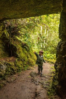 A boy in a cave in the Laurisilva forest of Los tilos de Moya, Gran Canaria