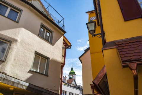 Historic architecture with a view of the church tower of St Martin in the old town of Wangen im