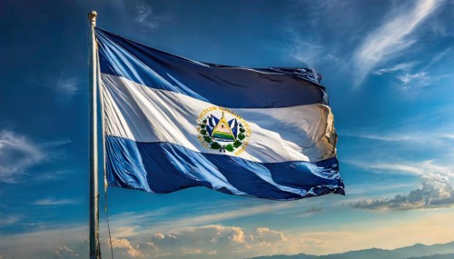The flag of El Salvador flutters in the wind, isolated against a blue sky