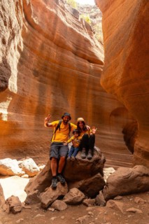 A family of tourists enjoying in the limestone canyon Barranco de las Vacas in Gran Canaria, Canary