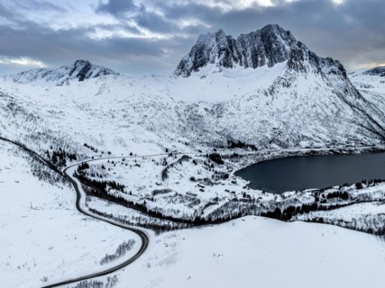 Aerial view of Bergen by the sea, fjord, winding road, winter, snow, Senja, Troms, Norway, Europe