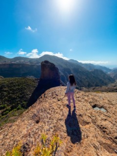 A woman tourist at the Roque Palmes viewpoint near Roque Nublo in Gran Canaria, Canary Islands
