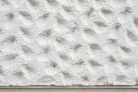 Roughly patterned plastered wall in detail, background and structure