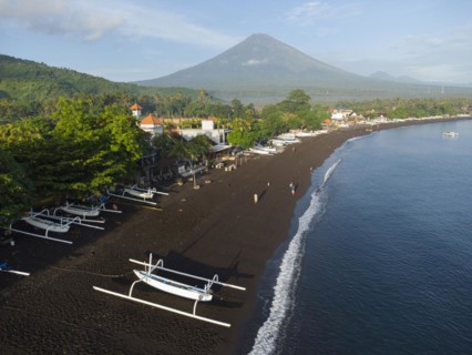 Fishermen loading fish from their outrigger boats in the morning on the black beach of Amed, Amed,