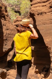 A tourist woman with hat in the limestone canyon Barranco de las Vacas in Gran Canaria, Canary