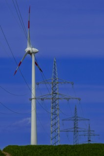 Power pylons with high-voltage lines and wind turbines at the Avacon substation in Helmstedt,