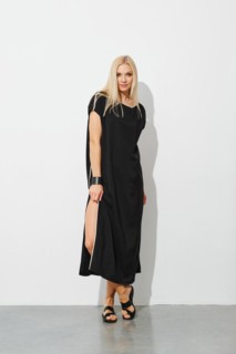 Charming blonde woman in black sleeveless dress and leather sandals