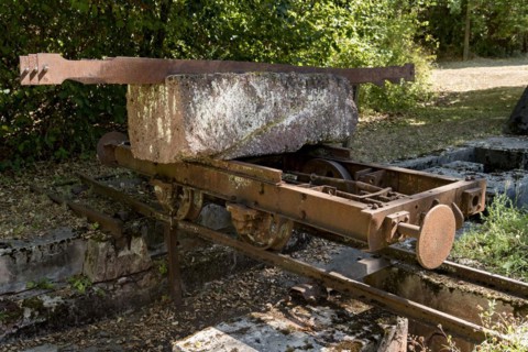 Rusty wagon, wagon on rail with block of Michelnau tuff, red basalt, red lava, slag agglomerate,