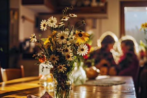Mother's Day, Cosy living room illuminated by natural light with a bouquet of sun hats, AI