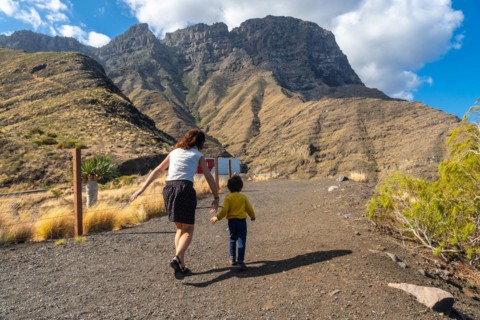 A mother and her son walking and having fun in the mountains of the Agaete coast, Roque Guayedra,
