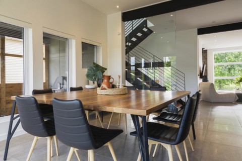 American walnut wood dining table and black leather sitting chairs with ash wood legs in dining