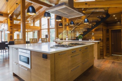 Bamboo wood island with white quartz countertops and high wicker chairs, buffet in kitchen with Ipe