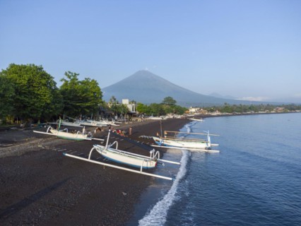 Fishermen loading fish from their outrigger boats in the morning on the black beach of Amed, Amed,