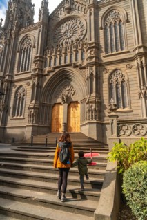 A mother with her son visiting the Church of San Juan Bautista, Arucas Cathedral, Gran Canaria,