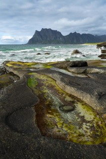 Seascape on the beach at Uttakleiv (Utakleiv), with rocks and water-filled rocky outcrops in the