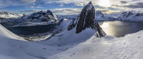 Aerial view of Bergen by the sea, fjord, sunbeams, winter, snow, panorama, Mount Segla, Senja,