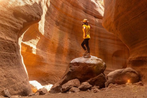 Adventurous tourist woman in the limestone canyon Barranco de las Vacas in Gran Canaria, Canary