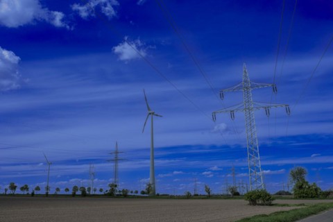 Power pylons with high-voltage lines on the K63 road with trees at the Avacon substation Helmstedt,