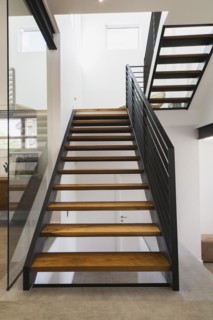 American walnut wood and black powder coated cold rolled steel stairs inside modern cube style