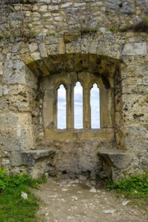 Gothic tracery window in an old fragment of wall, ruins of the medieval Hohenurach Castle, Bad
