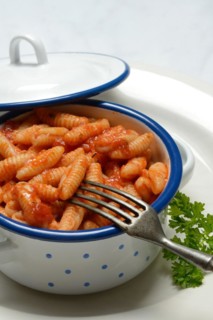 Malloreddus, Sardinian gnocchetti with tomato sauce in a bowl, traditional pasta variety from