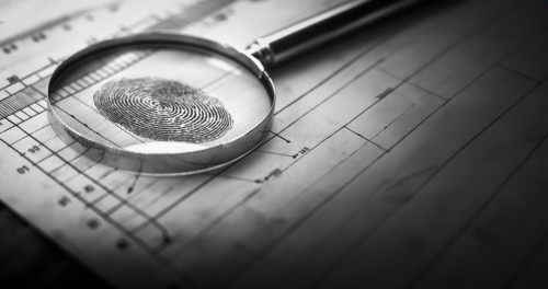 Magnifying glass resting on a fingerprint on paper. generative AI, AI generated