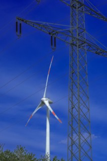 Electricity pylon with high-voltage lines and wind turbine at the Avacon substation Helmstedt,