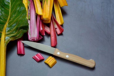 Red and yellow chard, kitchen knife and chopped stems, Beta vulgaris