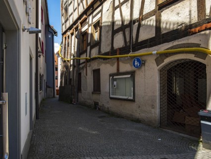 View through the Trinklaube, a winding narrow alley in the old town of Wangen im Allgaeu, Upper