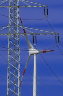 Power pylon with high-voltage lines and wind turbines at the Avacon substation Helmstedt,