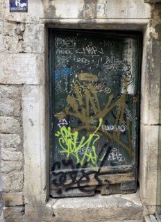Graffiti-covered door in a stone building, Split, Dalmatia, Croatia, Europe