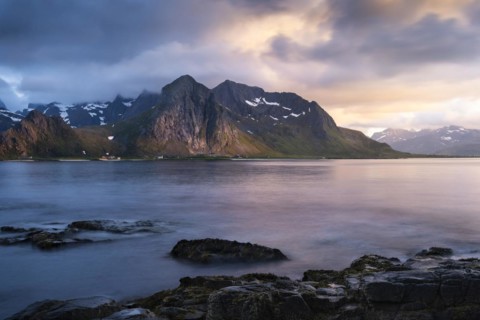 Landscape with sea and mountains on the Lofoten Islands, view across the fjord to the small town of