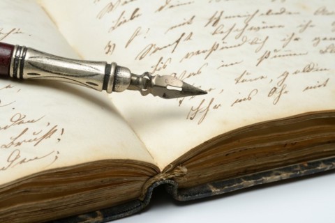 Pen on diary with old writing