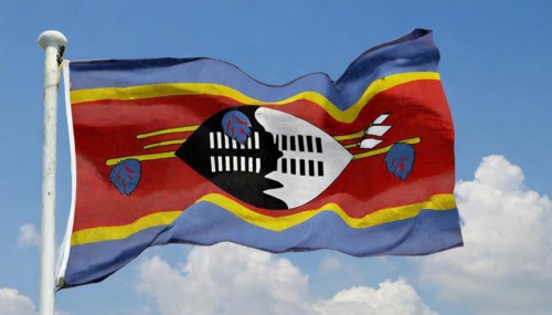 The flag of Swaziland, Kingdom of Eswatini, flutters in the wind, isolated, against the blue sky