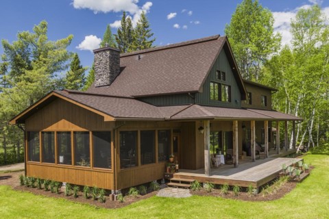 Elevated rear view of brown and green stained spruce wood and cedar shingle siding LEED certified