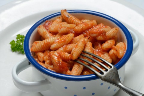 Malloreddus, Sardinian gnocchetti with tomato sauce in a bowl, traditional pasta variety from