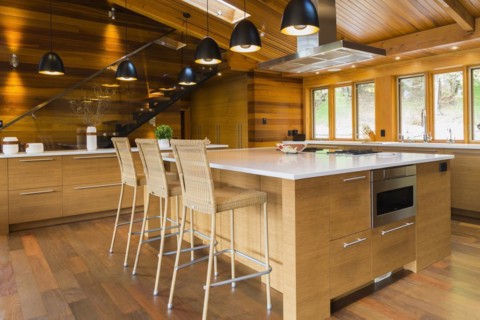 Bamboo wood island with white quartz countertops and high wicker chairs, buffet in kitchen with Ipe