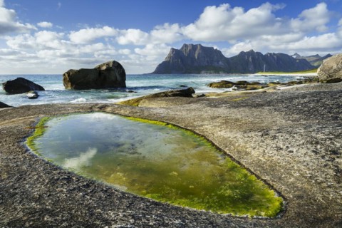 Seascape on the beach at Uttakleiv (Utakleiv), in the foreground rocks and a rocky outcrop filled