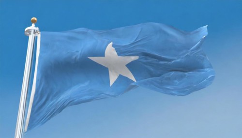 The flag of Somalia, fluttering in the wind, isolated, against the blue sky