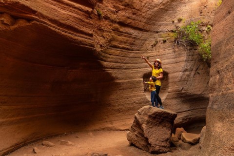 Mother and son enjoying in the limestone canyon Barranco de las Vacas in Gran Canaria, Canary