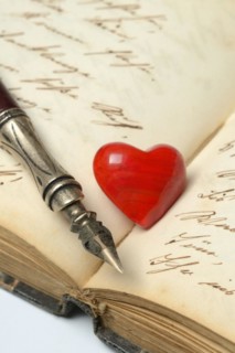 Pen with pen holder and red heart on diary