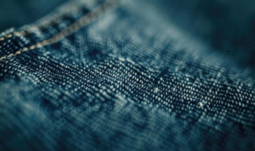 Closeup view of dark indigo denim material AI generated