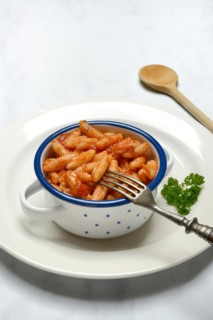Malloreddus, Sardinian gnocchetti with tomato sauce in a bowl, traditional pasta variety from