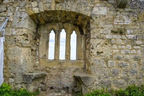 Gothic tracery window in an old fragment of wall, ruins of the medieval Hohenurach Castle, Bad