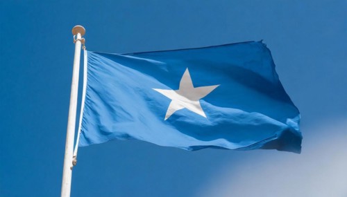 The flag of Somalia, fluttering in the wind, isolated, against the blue sky